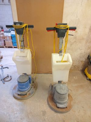two machines that are sitting on the floor in the room