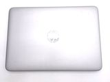 a white laptop sitting on top of a white table