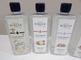 four bottles of colognes are lined up on a table