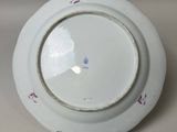 a white plate with a red and blue design on it