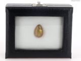 an oplite stone in a black box on a white surface