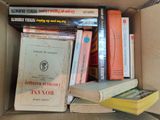 many books in a box on the table