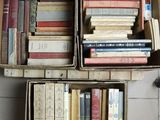 boxes of books are stacked on top of each other on a tiled floor