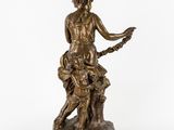 a bronze statue of a woman holding a child