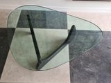 a glass table with a black handle on top of it