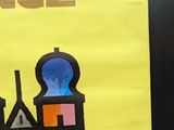 a yellow poster with a castle on it on the wall