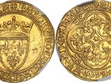 a gold coin with a crown and shield on it