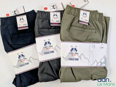three pairs of men ' s casual pants with labels on them