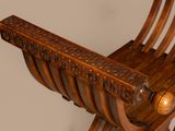 a wooden chair that has a wooden seat on it