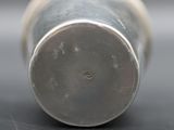 a close up view of a silver cup on a table