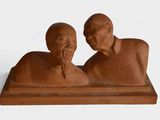 two figurines of a man and a woman sitting on a table