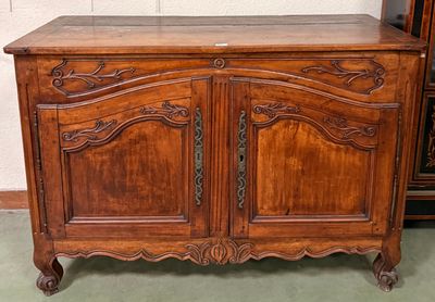a wooden cabinet with a marble top on a green floor