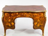 a small wooden table with a marble top on it
