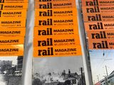 a lot of magazines on a table with a train in the background