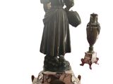 a statue of a woman holding a vase next to a vase