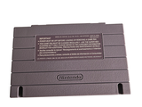 a gray nintendo game console sitting on top of a white table