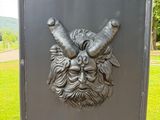 a statue of a man with a horned face on it
