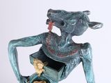 statue of a man holding a box with a cat inside of it