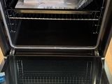 a black oven with a glass door and a rack in it