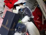 a suitcase full of items that are sitting on a bed