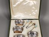 an assortment of silverware in a green case on a table