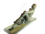 statue of a man sitting on a wooden base with a white background