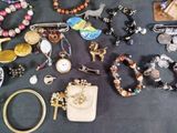 many different types of jewelry on a table