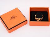 an orange box with a ring inside of it on a white surface