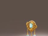 a close up of a gold and turquoise broochle broochle