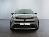 the front view of a silver car in a white room