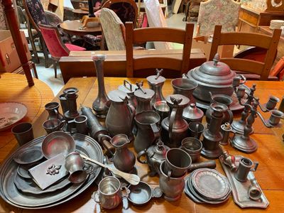 a lot of silverware on a table in a room