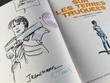 an open book with a drawing of a man holding a baseball bat