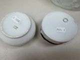 two white bowls sitting next to each other on a table