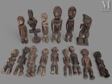 group of african carved figurines on a gray background