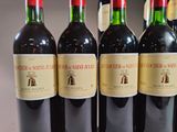 several bottles of wine are lined up on a table