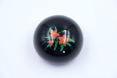 an image of a close up of a black ball with flowers on it
