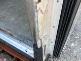 a metal grate on the ground next to a door