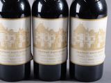 three bottles of wine sitting on top of a table next to each other
