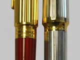 two pens sitting next to each other on a table