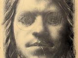 an old photo of a man with glasses and long hair
