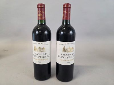 two bottles of red wine sitting next to each other on a table