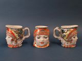 trois tasses en céramique ornées de motifs différents sur un fond bleu
