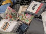 a pile of clothes and blankets in a shopping cart