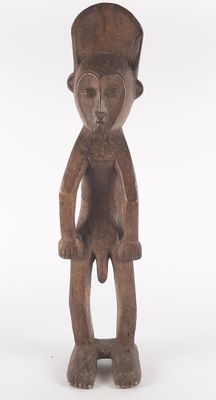 an old wooden statue of a man with a hat on his head
