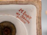 a close up of a white and red vase with red writing on it