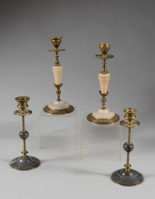 three brass candlesticks with marble and glass bases