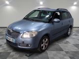 a picture of a small blue car parked in a garage