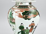 a vase with a lid that has a painting on it