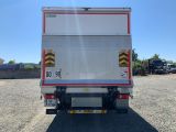 the back of a white truck parked in a parking lot