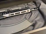 a gun in a box with a magazine in it